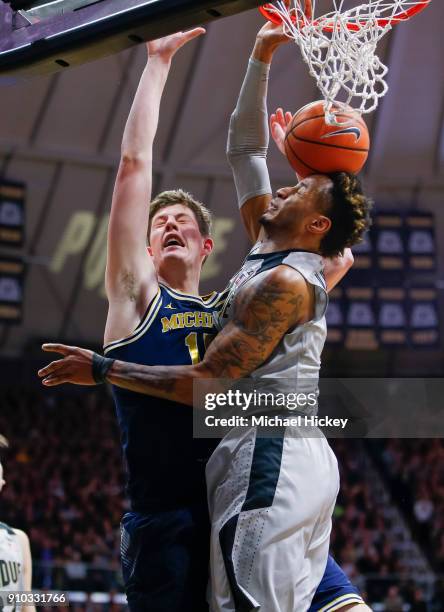 Jon Teske of the Michigan Wolverines shoots the ball against Vincent Edwards of the Purdue Boilermakers at Mackey Arena on January 25, 2018 in West...