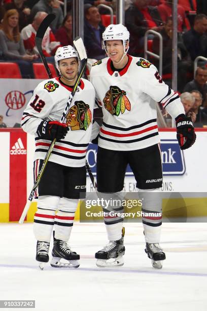 Alex DeBrincat of the Chicago Blackhawks celebrates his first period goal with Connor Murphy while playing the Detroit Red Wings at Little Caesars...