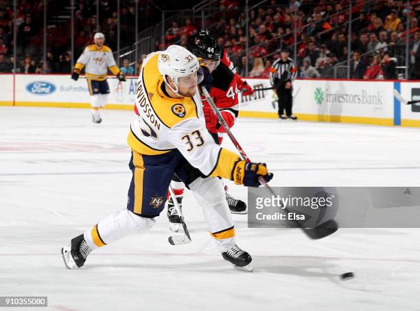 Viktor Arvidsson of the Nashville Predators scores a short handed goal as Miles Wood of the New Jersey Devils defends in the third period on January...
