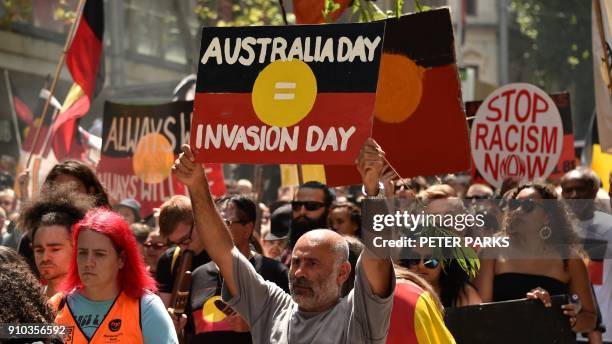 People take part in an "Invasion Day" rally on Australia Day in Melbourne on January 26, 2018. Thousands of supporters joined rallies across...