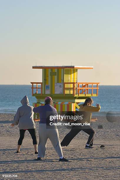 yoga and tai chi on the beach - tai chi shadow stock pictures, royalty-free photos & images