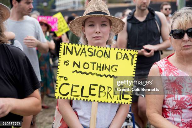 Woman holds a sign before an Invasion Day march in Redfern on January 26, 2018 in Sydney, Australia. Australia Day, formerly known as Foundation Day,...