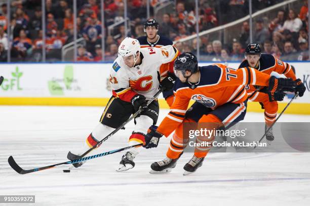 Oscar Klefbom of the Edmonton Oilers defends the zone against Garnet Hathaway of the Calgary Flames at Rogers Place on January 25, 2018 in Edmonton,...