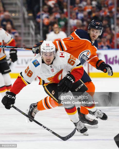 Oscar Klefbom of the Edmonton Oilers defends against Ryan Lomberg of the Calgary Flames at Rogers Place on January 25, 2018 in Edmonton, Canada.