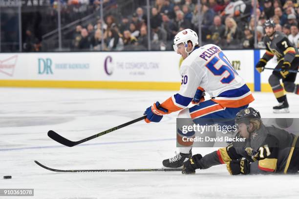 William Karlsson of the Vegas Golden Knights dives to knock the puck away from Adam Pelech of the New York Islanders during the game at T-Mobile...