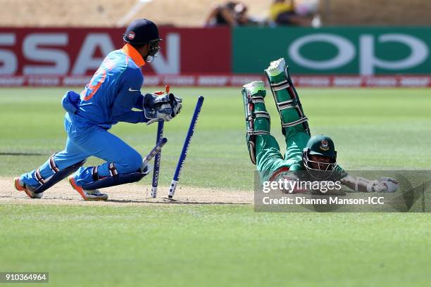 Harvik Desai of India runs out Aminul Islam Biplob of Bangladesh during the ICC U19 Cricket World Cup match between India and Bangladesh at John...