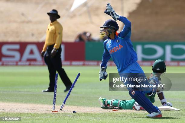 Harvik Desai of India celebrates the run out of Aminul Islam Biplob of Bangladesh during the ICC U19 Cricket World Cup match between India and...