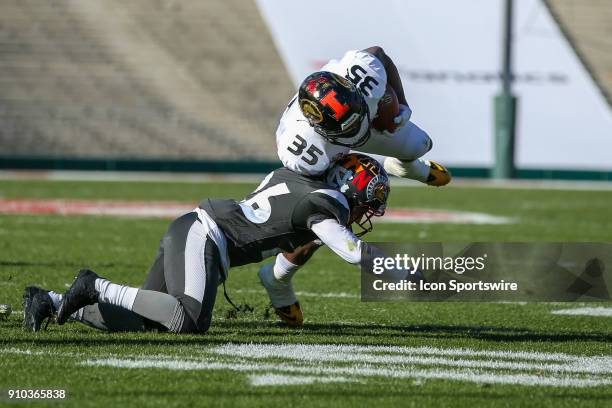 National fullback Daniel Marx from Stanford runs the ball for a gain as he's is tackles by National cornerback Blaise Taylor from Arkansas State...