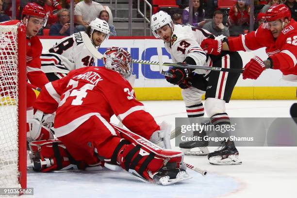 Petr Mrazek of the Detroit Red Wings makes a first period save on Tomas Jurco of the Chicago Blackhawks at Little Caesars Arena on January 25, 2018...