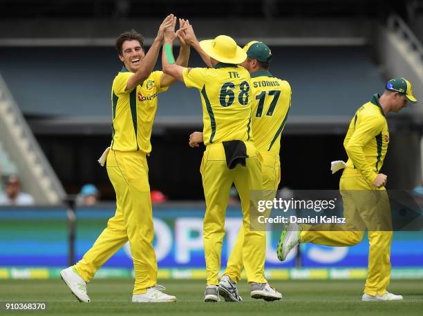 Patrick Cummins of Australia celebrates with his team mates after taking a wicket during game four of the One Day International series between...