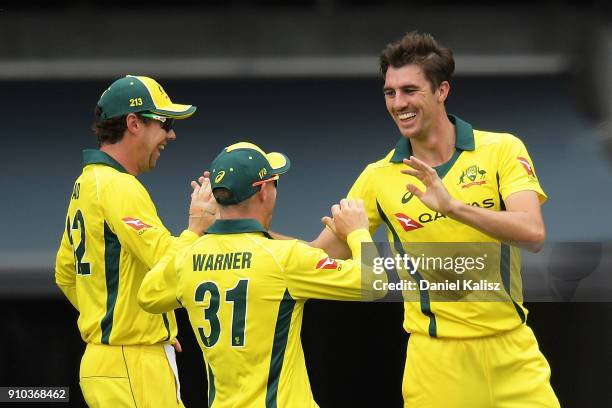 Patrick Cummins of Australia celebrates with his team mates after taking a wicket during game four of the One Day International series between...