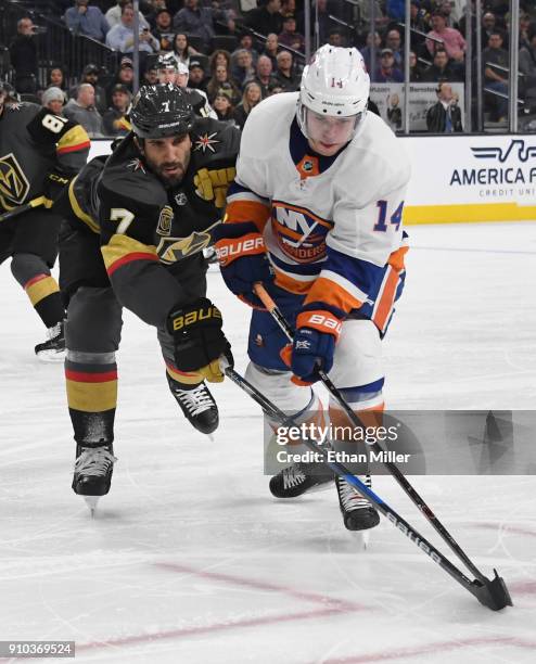 Thomas Hickey of the New York Islanders skates with the puck against Jason Garrison of the Vegas Golden Knights in the first period of their game at...