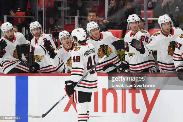 Chicago Blackhawks left wing Vinnie Hinostroza gets congratulations from the bench after scoring the third goal of the game during the Detroit Red...