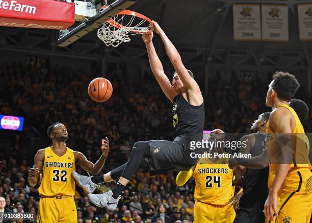 Rokas Ulvydas of the UCF Knights dunks the ball against Markis McDuffie and Shaquille Morris of the Wichita State Shockers during the second half on...
