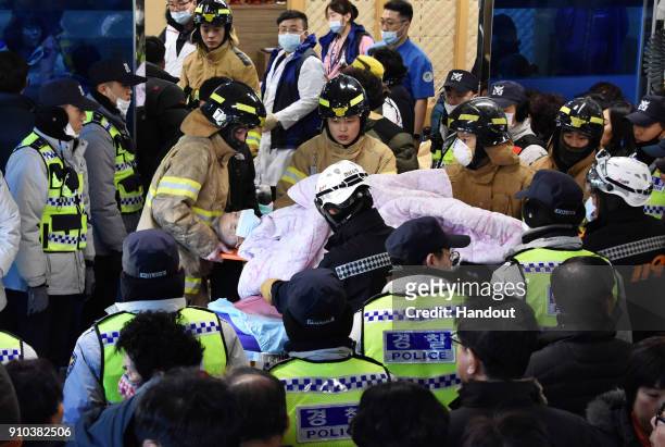In this handout picture provided by the Kim Gu Yeon-Gyeongnam Domin Ilbo, Rescue workers remove a survivor from a hospital fire on January 26, 2018...