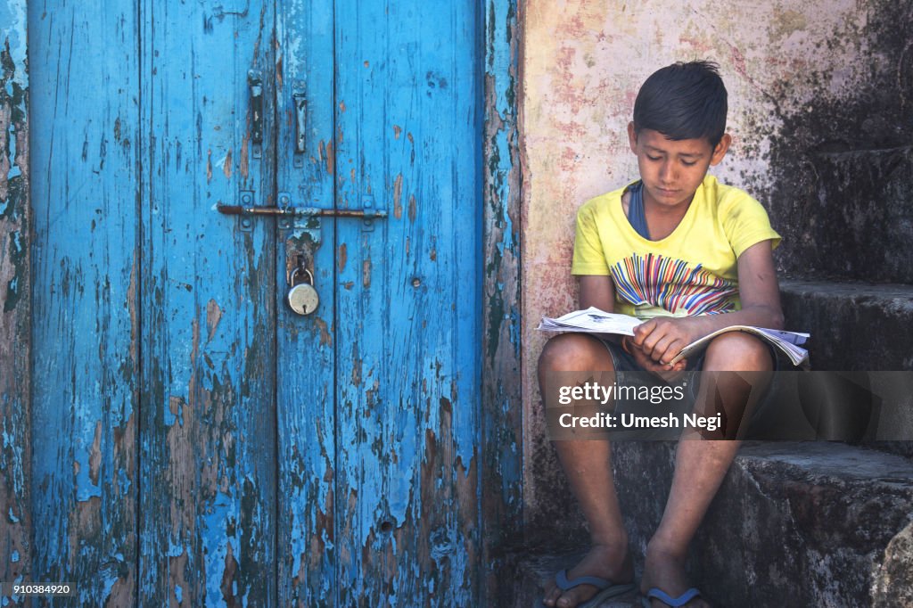 Kid reading near locked door