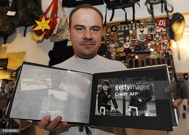 Former German shot putter Andreas Krieger, who competed as a woman on the East German athletics team, poses with a picture of himself in 1986-87)...