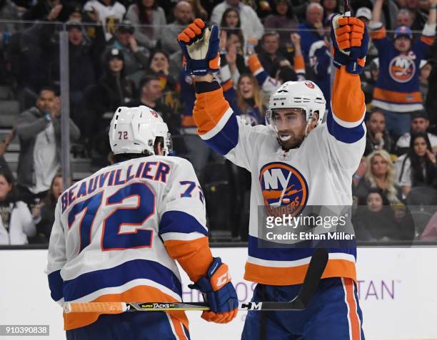 Anthony Beauvillier of the New York Islanders celebrates with teammate Jordan Eberle after Beauvillier assisted Eberle on a third-period goal against...