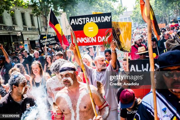 Protestors holding placards march during a protest by Aboriginal rights activist on Australia Day in Melbourne, Australia 26 January 2018. Australia...