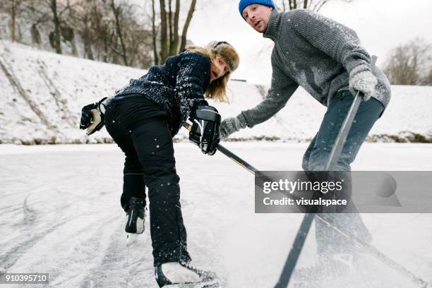 two friends playing hockey - ice hockey player stock pictures, royalty-free photos & images