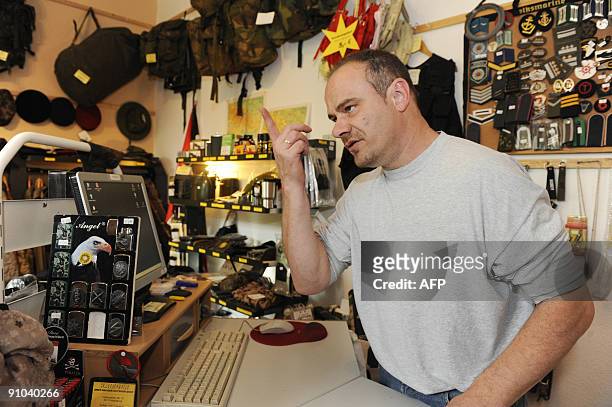 Former German shot putter Andreas Krieger, who competed as a woman on the East German athletics team, speaks to an AFP reporter in his shop in...