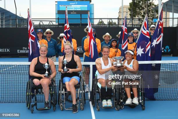 Aniek Van Koot of the Netherlands and Diede De Groot of the Netherlands pose for a photo with their runners-up trophy and Marjolein Buis of the...