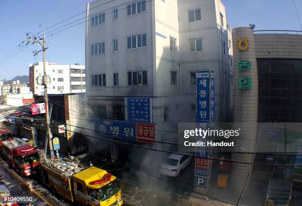 In this handout picture provided by the Kim Gu Yeon-Gyeongnam Domin Ilbo, The death toll more than 30 as rescue workers searched a scorched,...