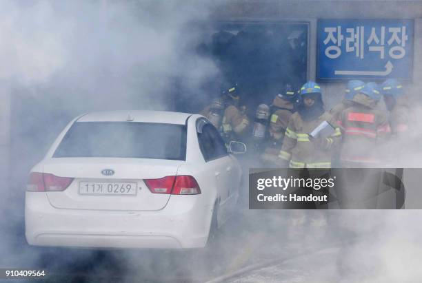 In this handout picture provided by the Kim Gu Yeon-Gyeongnam Domin Ilbo, The death toll more than 30 as rescue workers searched a scorched,...