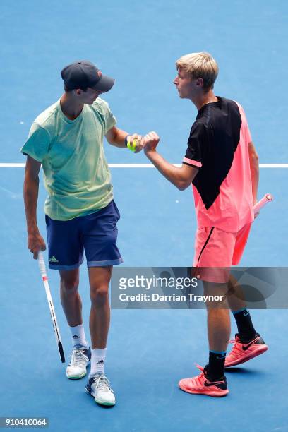 Henri Squire of Germany and Rudolf Molleker of Germany talk tactics in the boy's doubles final against Hugo Gaston of France and Clement Tabur of...