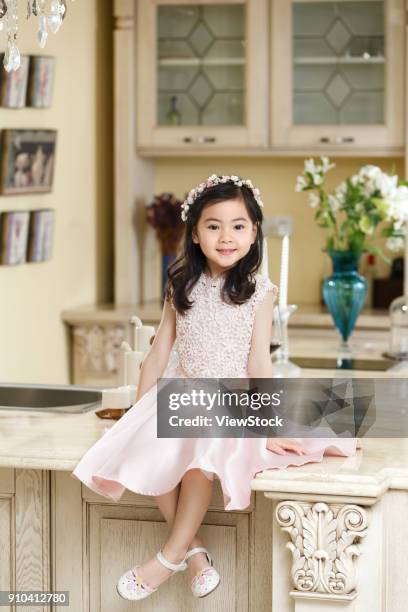 a little girl in a dress - kitchen dresser stock pictures, royalty-free photos & images