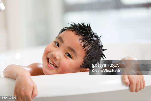 the cute little boy is taking a bath - running water bath stock pictures, royalty-free photos & images