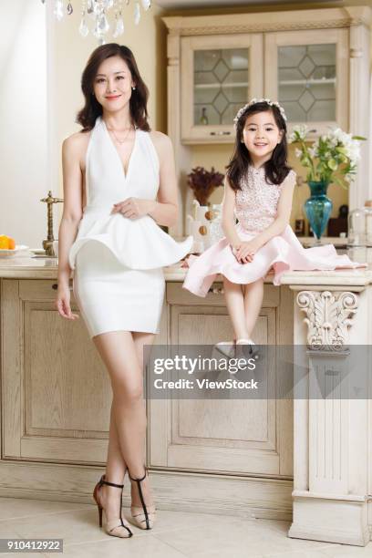 fashionable dress mother and daughter - kitchen dresser stock pictures, royalty-free photos & images