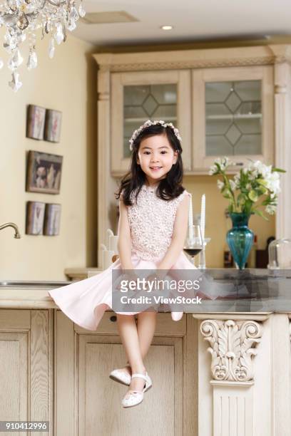 a little girl in a dress - küchenbuffet stock-fotos und bilder