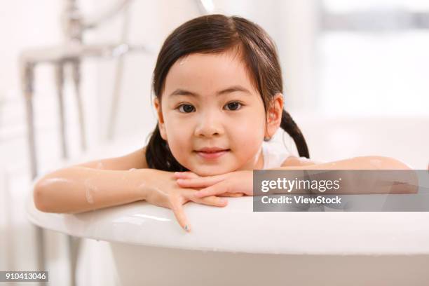 the lovely little girl is taking a bath - running water bath stock pictures, royalty-free photos & images