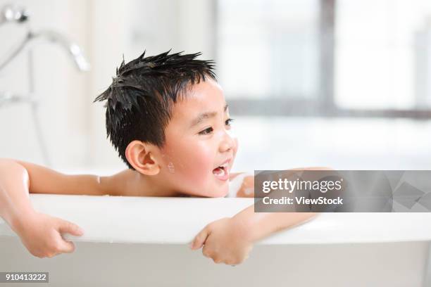 the cute little boy is taking a bath - running water bath stock pictures, royalty-free photos & images