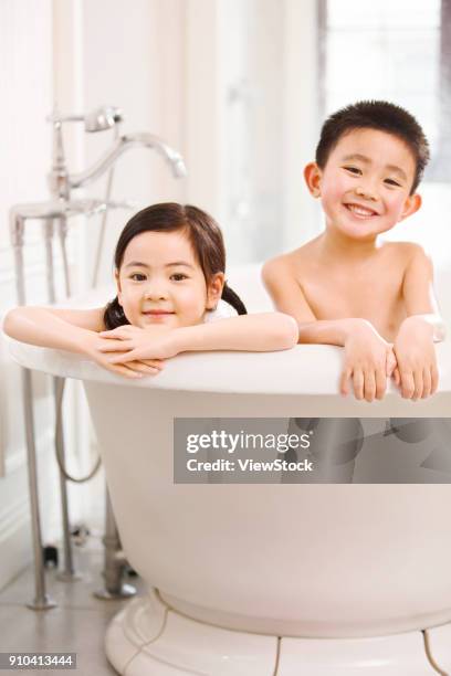 the lovely boy and girl are in the bathtub - sunken bath stock pictures, royalty-free photos & images