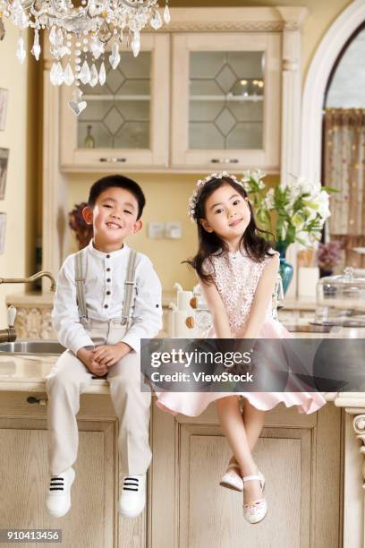 boys and girls in dresses - kitchen dresser stock pictures, royalty-free photos & images