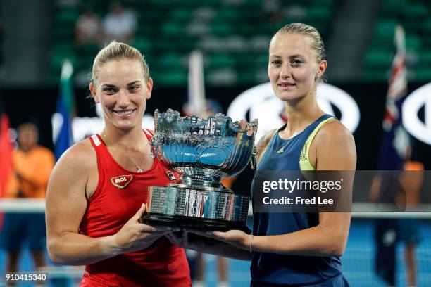 Kristina Mladenovic of France and Timea Babos of Hungary pose for a photo with the championship trophy after winning the women's doubles final...