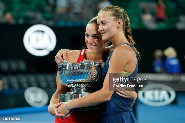 Kristina Mladenovic of France and Timea Babos of Hungary pose for a photo with the championship trophy after winning the women's doubles final...