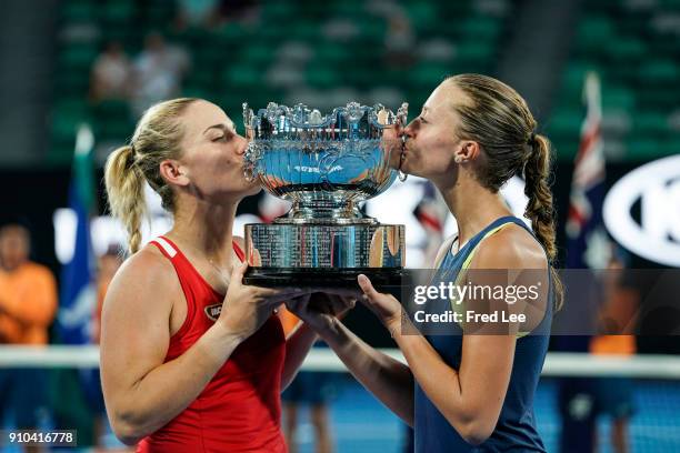 Kristina Mladenovic of France and Timea Babos of Hungary pose for a photo with the championship trophy after winning the women's doubles final...