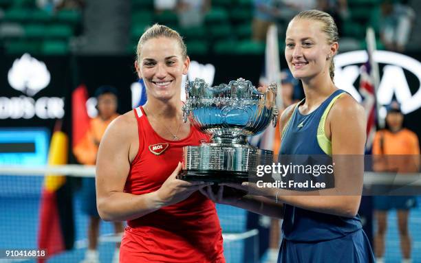 Kristina Mladenovic of France and Timea Babos of Hungary pose for a photo with the championship trophy after winning the women's doubles final...