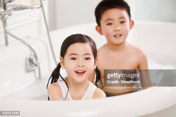 the lovely boy and girl are in the bathtub - sunken bath stock pictures, royalty-free photos & images