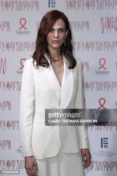 French actress and model Aymeline Valade poses upon arriving to the Diner de la Mode fundraiser dinner, to benefit the French anti-AIDS association...