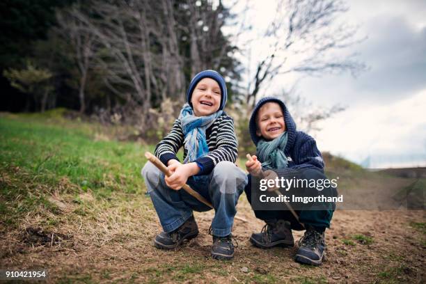 little boys having fun hiking on a spring day. - frat boys stock pictures, royalty-free photos & images