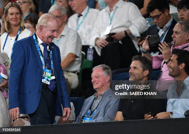 Australian tennis legend Rod Laver speaks with actor Eric Bana and former Formula one driver Mark Webber as he arrives to watch Switzerland's Roger...