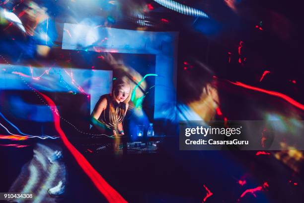 woman dj performing at rave event in nightclub - the celebrity experience panel stock pictures, royalty-free photos & images