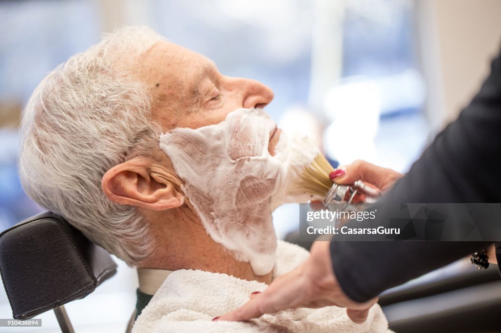 Applying Shaving Cream on Senior Man Side View