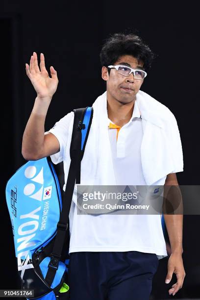 Dejected Hyeon Chung of South Korea waves to the crowd after retiring hurt in his semi-final match against Roger Federer of Switzerland on day 12 of...
