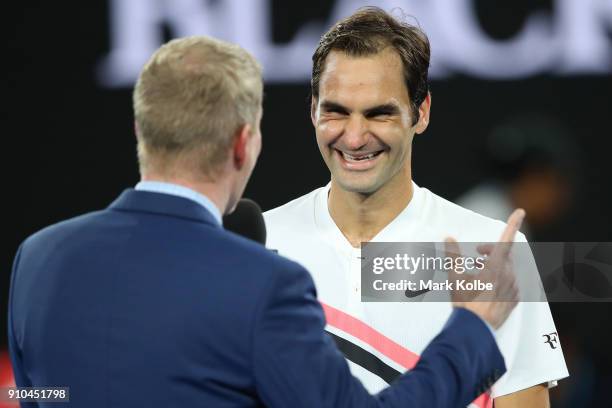 Roger Federer of Switzerland is interviewed by commentator Jim Courier after winning his semi-final match against Hyeon Chung of South Korea on day...