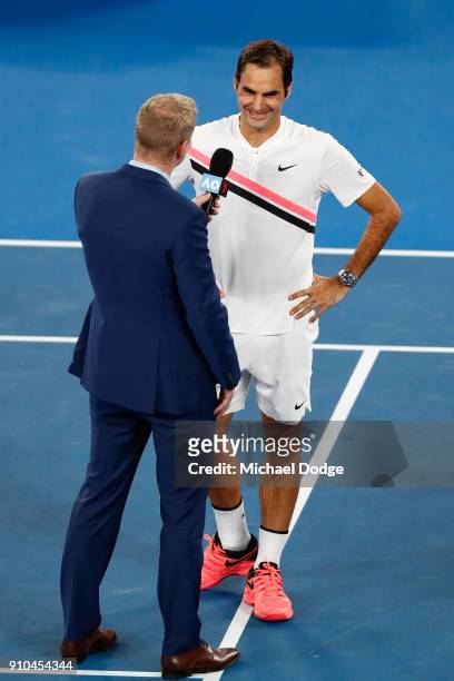 Roger Federer of Switzerland is interviewed by commentator Jim Courier after winning his semi-final match against Hyeon Chung of South Korea on day...